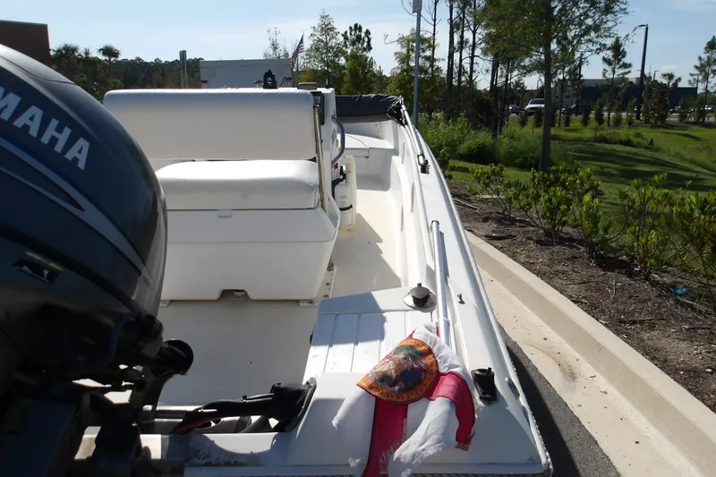 Slide: The Image of 2002 Wellcraft 160 Fisherman boat with Yamaha engine, parked near greenery. - 5