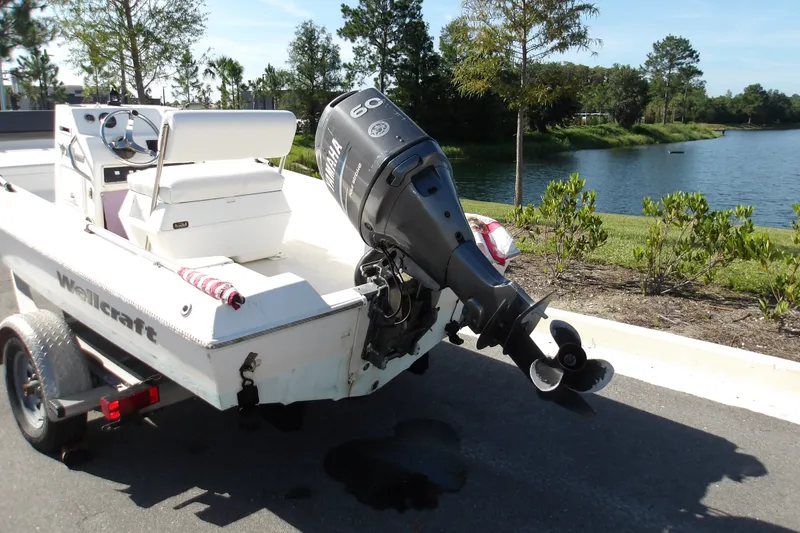 Slide: The Image of 2002 Wellcraft 160 Fisherman boat with Yamaha outboard motor by a lakeside. - 13