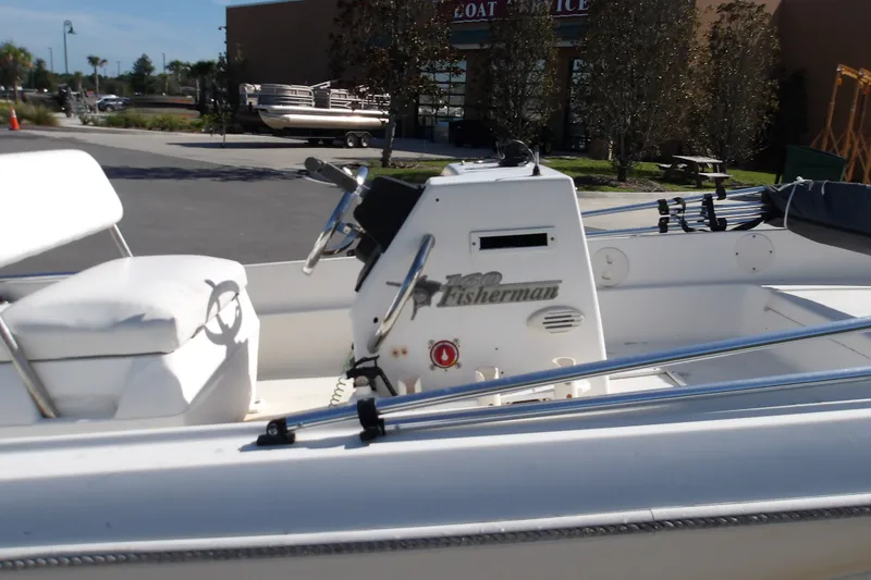 Slide: The Image of 2002 Wellcraft 160 Fisherman boat interior with steering console and seating. - 8