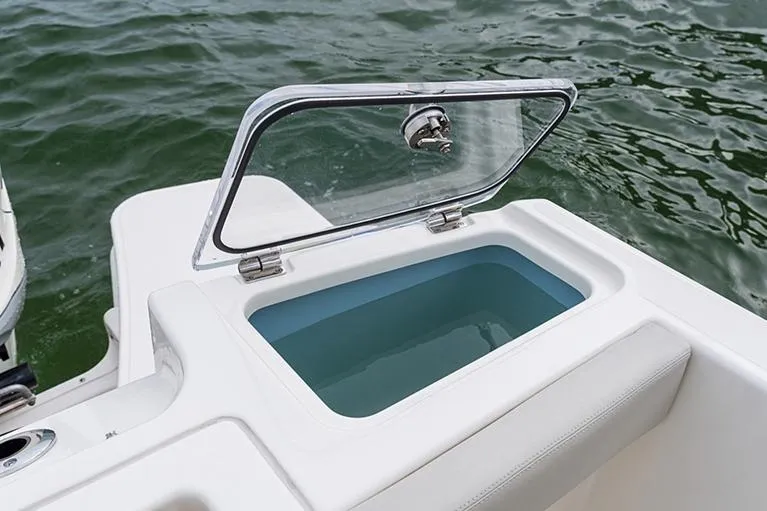 Slide: The Image of Manufacturer Provided Image: Open storage compartment on 2026 Boston Whaler 280 Vantage boat, near water. - 13
