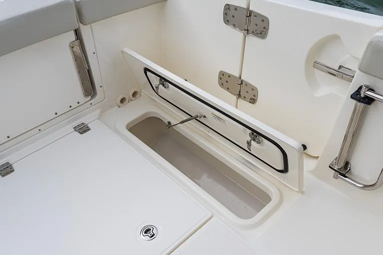 Slide: The Image of Manufacturer Provided Image: 2026 Boston Whaler 280 Vantage boat storage compartment with open hatch and stainless steel hinges. - 14