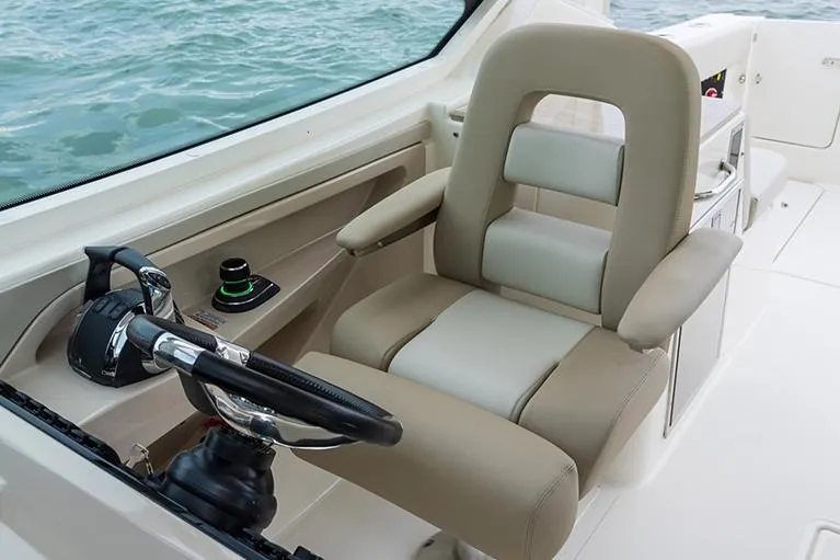 Slide: The Image of Manufacturer Provided Image: 2026 Boston Whaler 280 Vantage helm seat with steering wheel, on calm water. - 8
