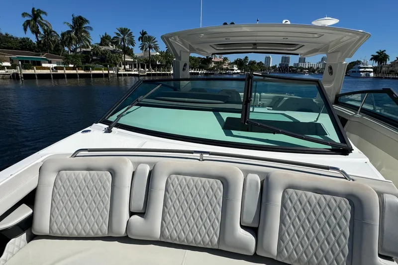 Slide: The Image of 2022 Sea Ray SLX 400 Outboard boat with luxurious seating and waterfront view. - 41