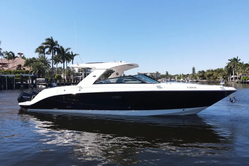 The Image of 2022 Sea Ray SLX 400 Outboard boat on a sunny waterfront with palm trees. - 0