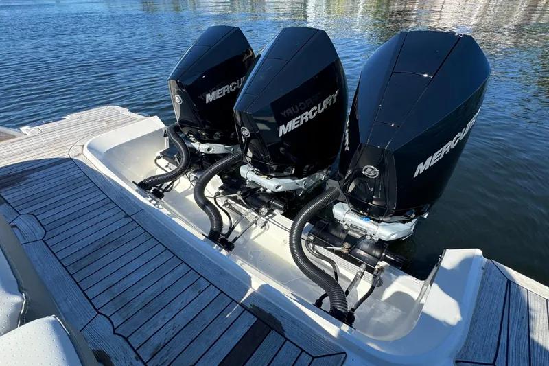 Slide: The Image of Triple Mercury outboard engines on a 2022 Sea Ray SLX 400, docked on water. - 21