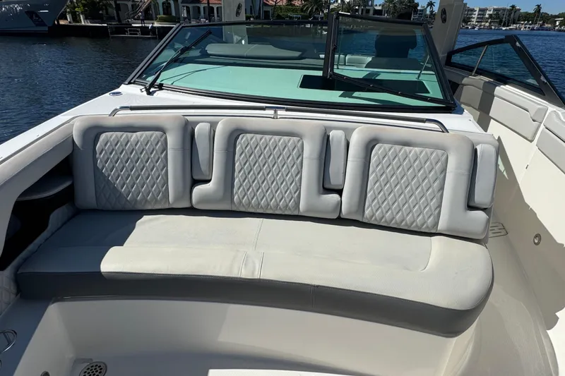 Slide: The Image of 2022 Sea Ray SLX 400 Outboard boat with luxurious seating and waterfront view. - 54