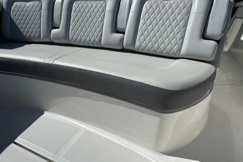 Slide: The Image of Luxurious seating on 2022 Sea Ray SLX 400 Outboard boat with diamond-pattern upholstery. - 52