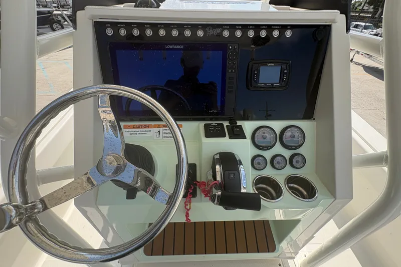 Slide: The Image of 2022 Ranger 2510 Bay boat dashboard with steering wheel, gauges, and navigation system. - 18