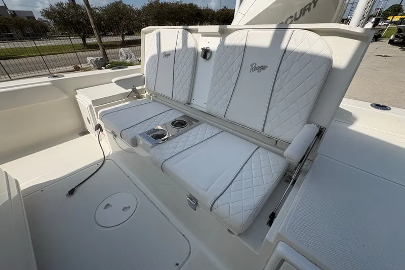 Slide: The Image of 2022 Ranger 2510 Bay boat with white cushioned seating and cup holders. - 19
