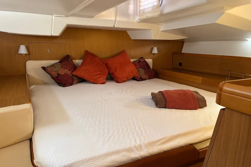 Slide: The Image of Cozy cabin interior of 2010 Jeanneau Sun Odyssey 42 DS with plush bedding and pillows. - 8