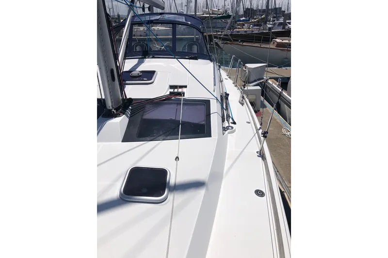 Slide: The Image of 2010 Jeanneau Sun Odyssey 42 DS sailboat docked at marina, showcasing deck and rigging. - 23
