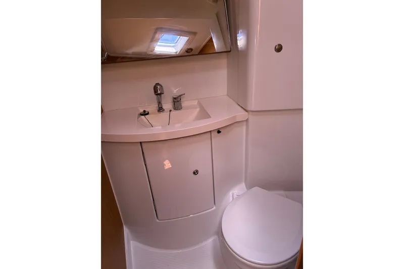 Slide: The Image of Bathroom interior of 2010 Jeanneau Sun Odyssey 42 DS yacht, featuring sink and toilet. - 6
