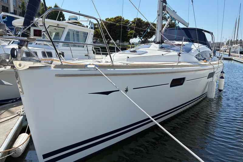 Slide: The Image of 2010 Jeanneau Sun Odyssey 42 DS sailboat docked in marina, showcasing sleek design and modern features. - 14