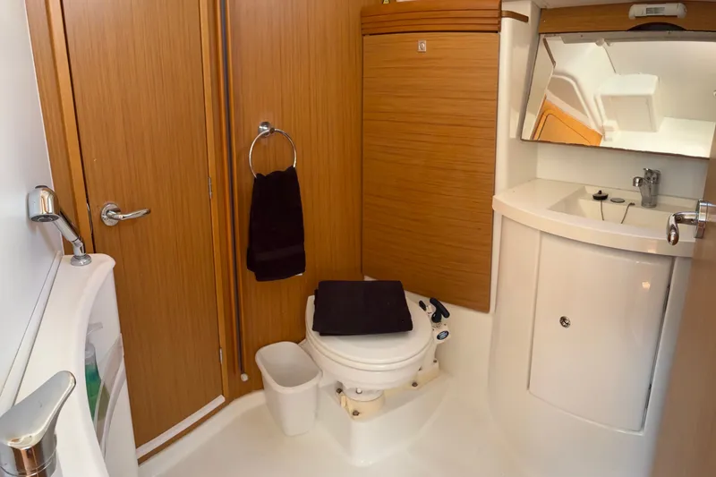 Slide: The Image of Bathroom interior of 2010 Jeanneau Sun Odyssey 42 DS yacht, featuring wooden cabinetry and modern fixtures. - 10