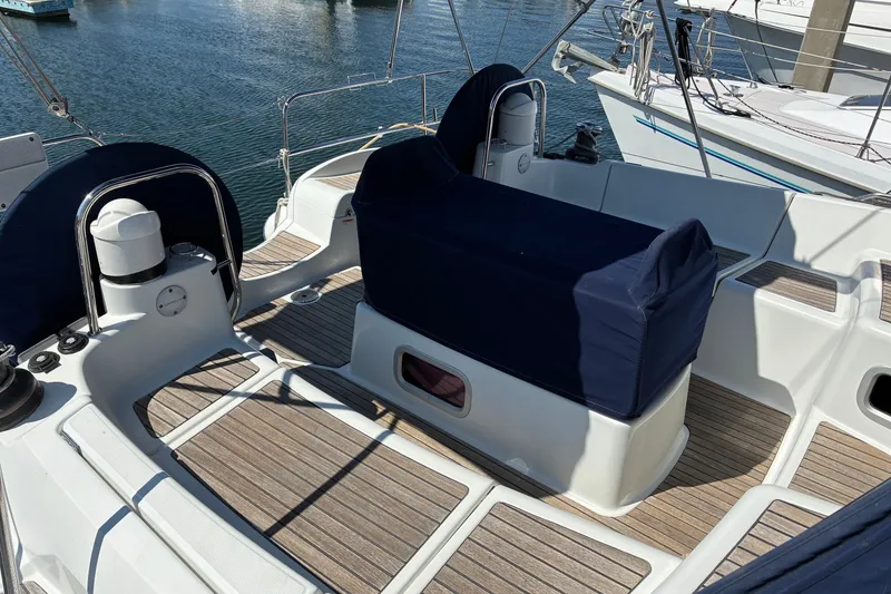 Slide: The Image of 2010 Jeanneau Sun Odyssey 42 DS yacht cockpit with covered seating and wooden deck. - 18