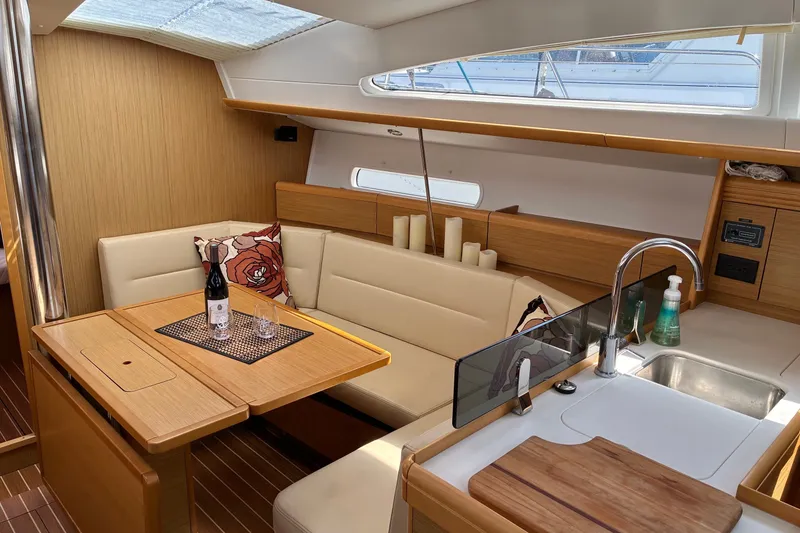 Slide: The Image of Interior of 2010 Jeanneau Sun Odyssey 42 DS yacht with cozy seating and dining area. - 3