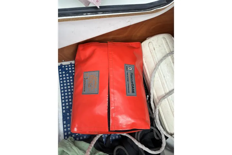Slide: The Image of Red rescue case on Jeanneau Sun Odyssey 42 DS, 2010 model, with safety equipment. - 19