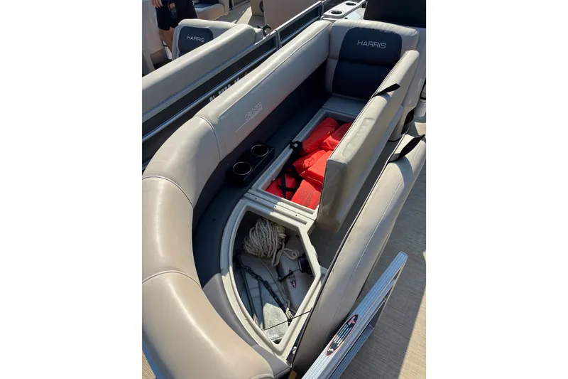 Slide: The Image of 2024 Harris Cruiser 230 boat interior with storage compartment and safety equipment. - 7