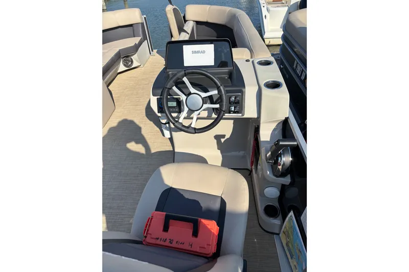 Slide: The Image of 2024 Harris Cruiser 230 boat interior with steering wheel and control panel. - 6