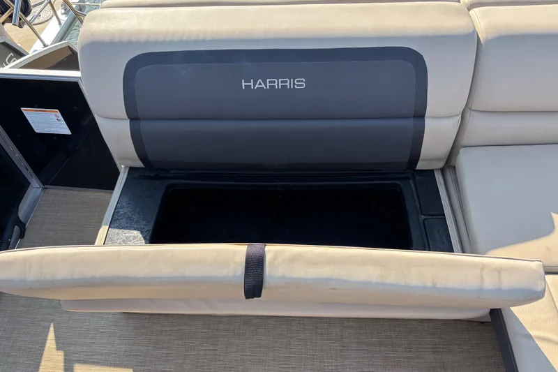 Slide: The Image of 2024 Harris Cruiser 230 boat seat with open storage compartment. - 9