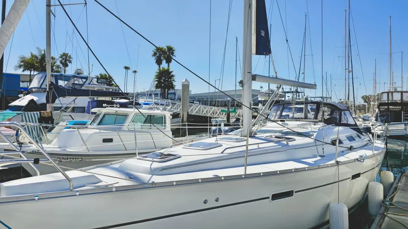 Slide: The Image of 2006 Beneteau 393 sailboat docked at marina with palm trees in background. - 4