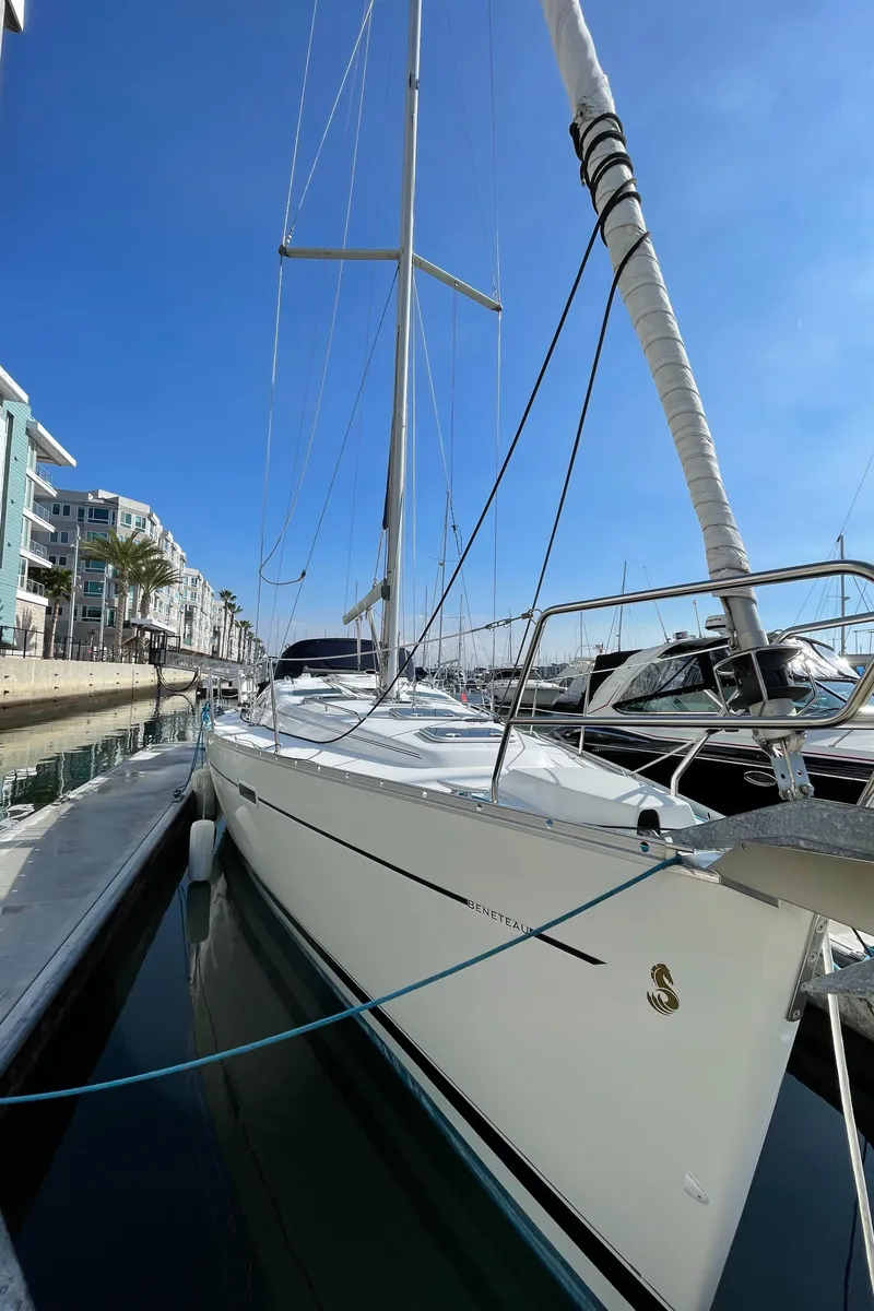Slide: The Image of 2006 Beneteau 393 sailboat docked in marina under clear blue sky. - 8