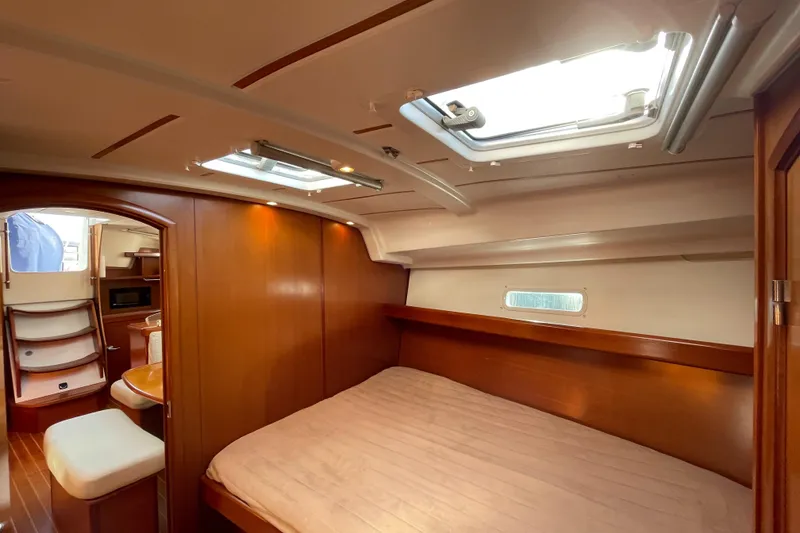 Slide: The Image of Interior of 2006 Beneteau 393 yacht cabin with wooden finish and skylights. - 28
