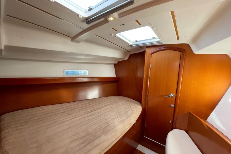 Slide: The Image of 2006 Beneteau 393 cabin interior with wooden finish and skylight. - 27