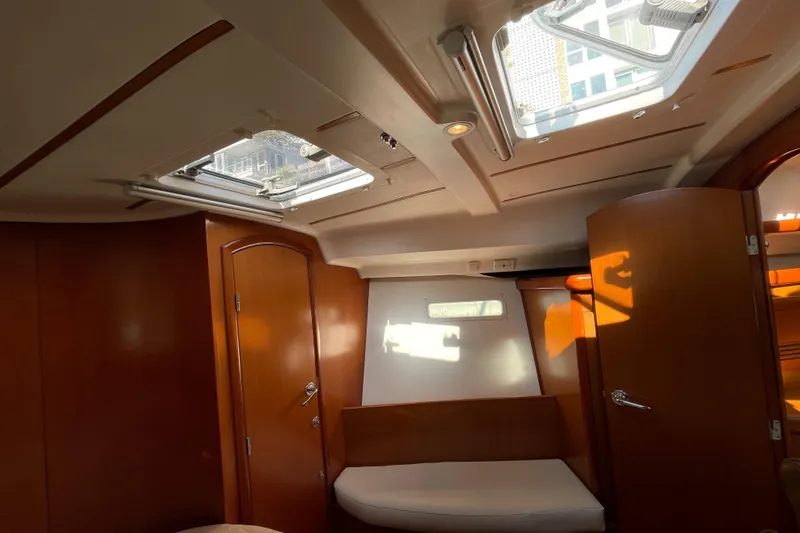 Slide: The Image of Interior of 2006 Beneteau 393 sailboat with wooden finish and skylights. - 29
