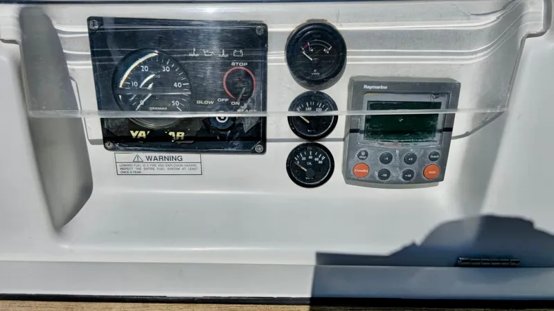 Slide: The Image of Control panel of a 2006 Beneteau 393 sailboat with gauges and Raymarine display. - 18