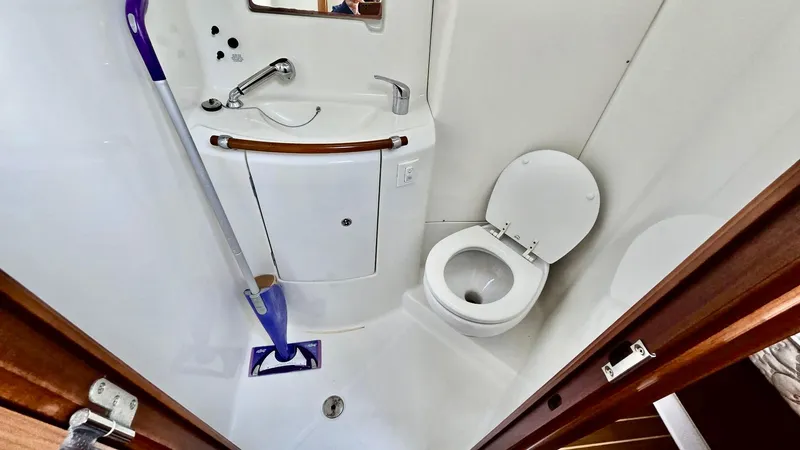Slide: The Image of Compact bathroom in 2006 Beneteau 393 yacht with sink, toilet, and mirror. - 33