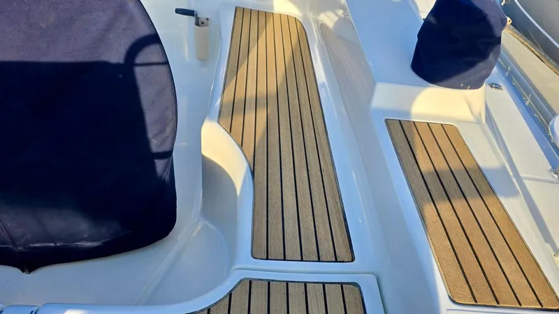 Slide: The Image of Beneteau 393 (2006) yacht deck with teak flooring and covered seating. - 9