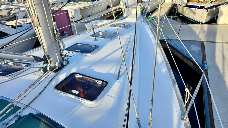 Slide: The Image of Deck view of a 2006 Beneteau 393 sailboat, showcasing hatches and rigging. - 14