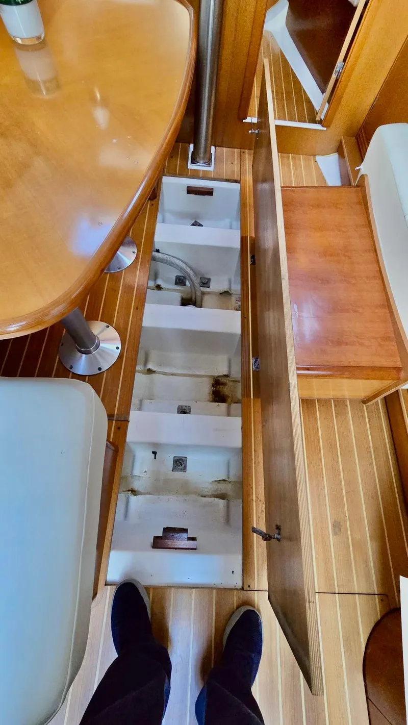 Slide: The Image of Interior view of a 2006 Beneteau 393 sailboat, showcasing open floor storage compartments. - 35