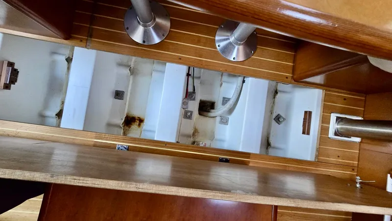 Slide: The Image of Interior view of a 2006 Beneteau 393 sailboat, showcasing underfloor compartments. - 36