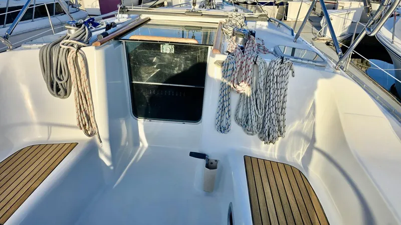 Slide: The Image of 2006 Beneteau 393 yacht cockpit with ropes and wooden flooring. - 13