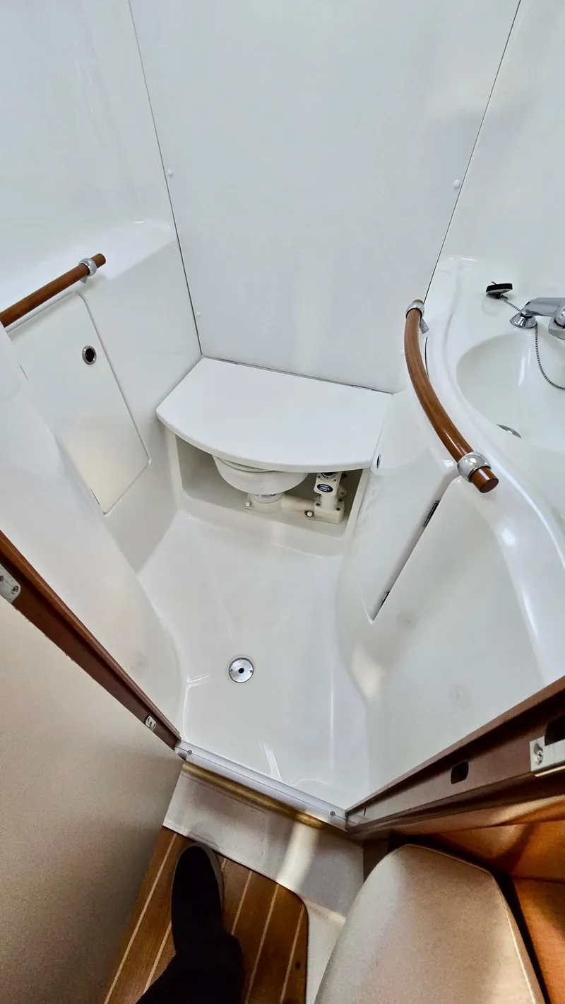 Slide: The Image of Beneteau 393 2006 yacht bathroom with compact design and modern fixtures. - 21