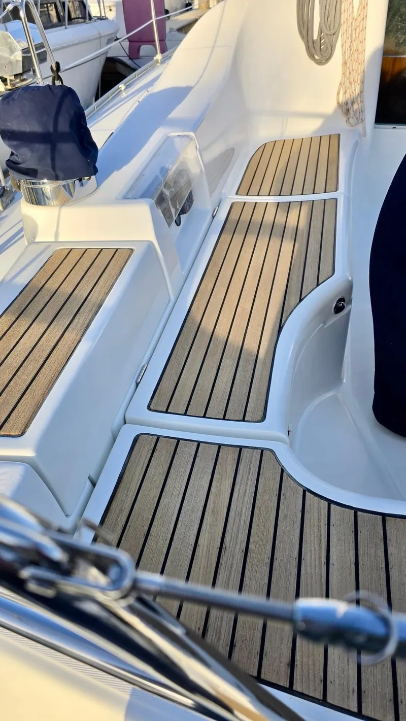 Slide: The Image of Beneteau 393 (2006) yacht deck with teak flooring and sleek design. - 11