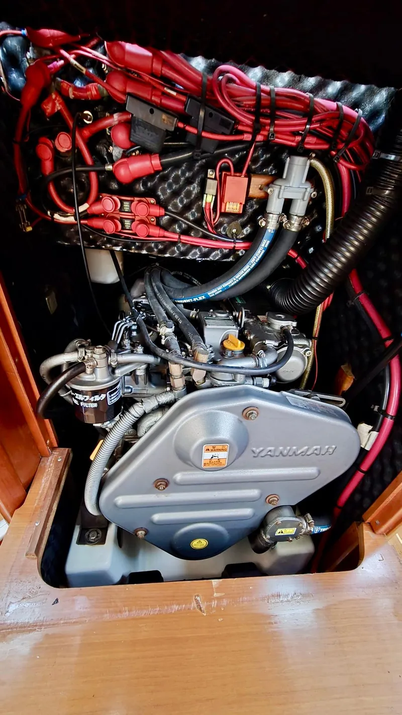Slide: The Image of Engine compartment of a 2006 Beneteau 393 sailboat, featuring a Yanmar engine. - 37