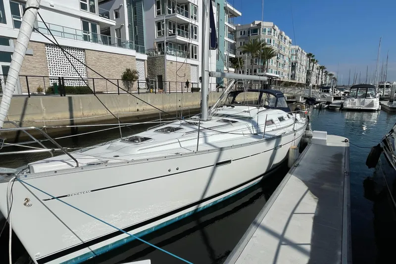 The Image of 2006 Beneteau 393 sailboat docked in a modern marina setting. - 0