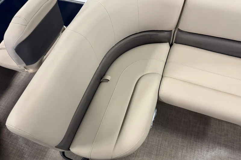 Slide: The Image of 2025 Sun Tracker Bass Buggy 18 DLX boat interior with beige cushioned seating. - 17