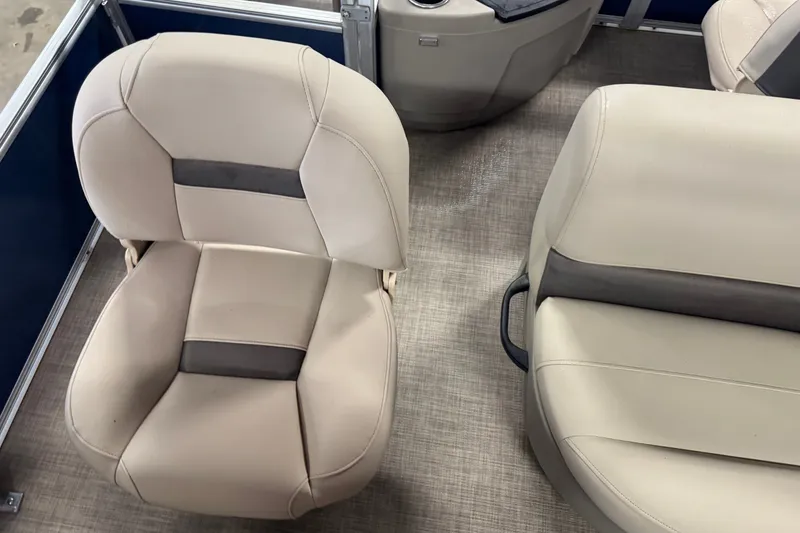 Slide: The Image of 2025 Sun Tracker Bass Buggy 18 DLX boat seats, featuring beige upholstery and modern design. - 13