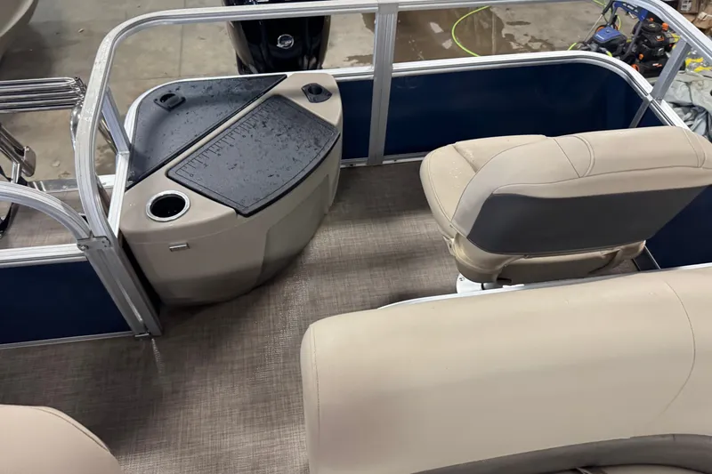 Slide: The Image of 2025 Sun Tracker Bass Buggy 18 DLX interior with beige seating and control panel. - 14