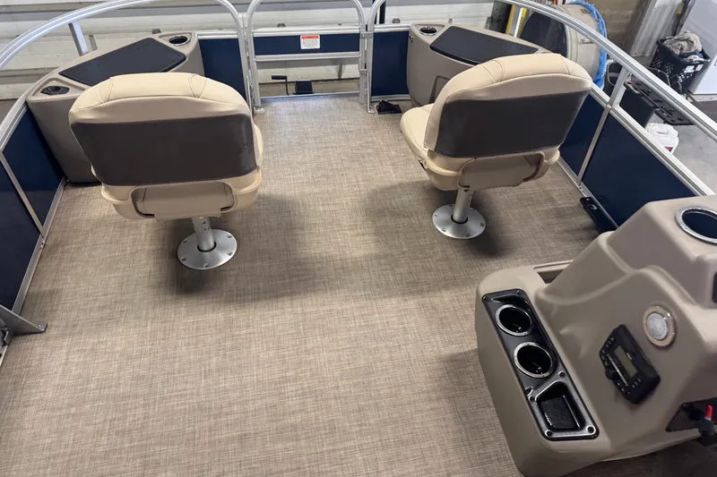 Slide: The Image of 2025 Sun Tracker Bass Buggy 18 DLX interior with beige seating and control panel. - 18