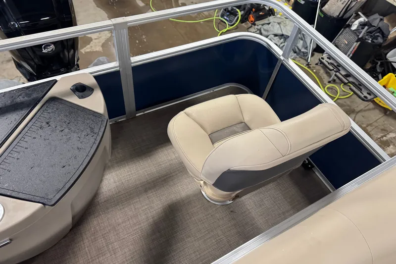 Slide: The Image of 2025 Sun Tracker Bass Buggy 18 DLX interior with beige seating and control panel. - 15