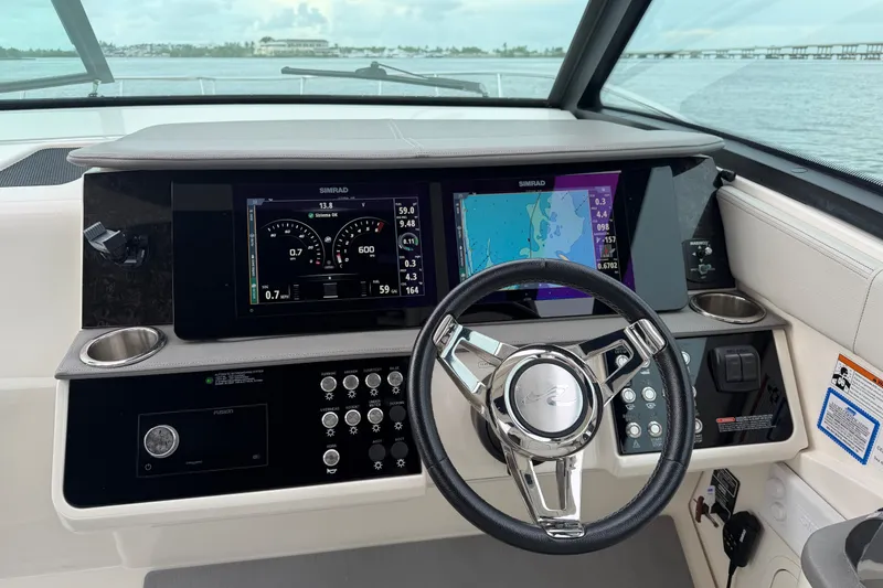 Slide: The Image of 2020 Sea Ray Sundancer 320 Coupe Outboard helm with advanced navigation displays. - 6