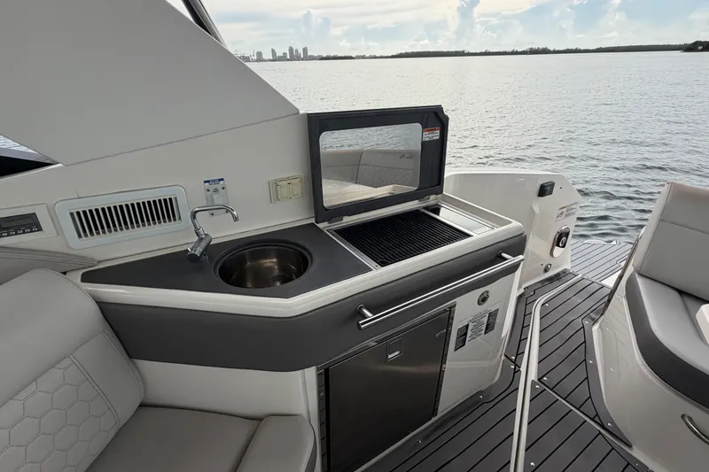 Slide: The Image of 2020 Sea Ray Sundancer 320 Coupe Outboard yacht kitchen with sink and grill. - 21
