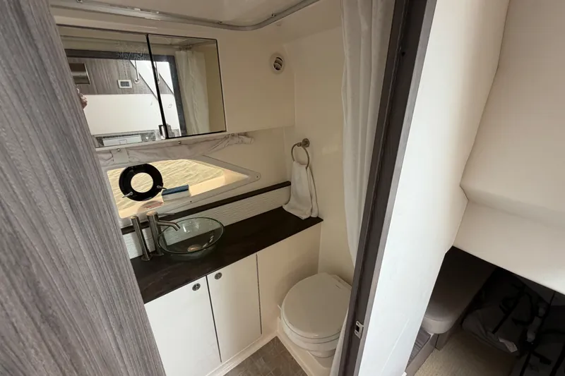 Slide: The Image of 2020 Sea Ray Sundancer 320 Coupe Outboard bathroom with modern sink and toilet. - 39