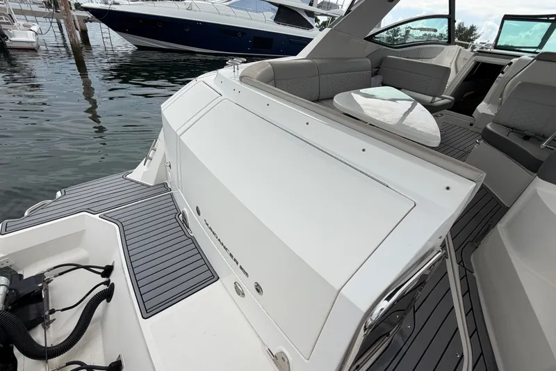 Slide: The Image of 2020 Sea Ray Sundancer 320 Coupe Outboard, featuring sleek deck and luxurious seating. - 50