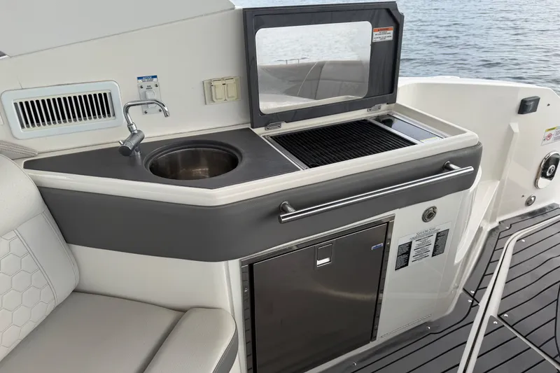 Slide: The Image of Outdoor kitchenette on 2020 Sea Ray Sundancer 320 Coupe Outboard with sink and grill. - 25